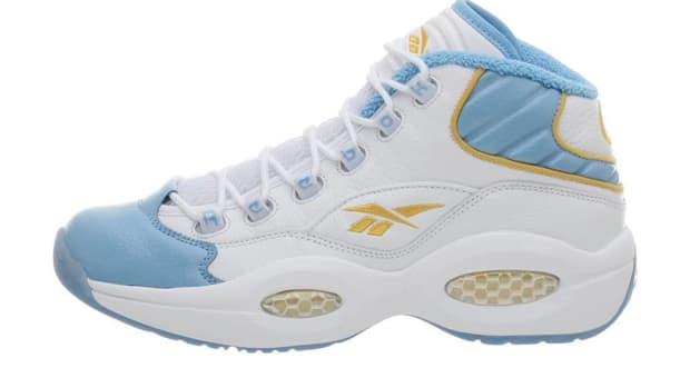 White and blue Reebok shoe.